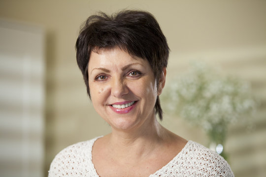 Portrait Of Attractive Mature Woman Casually Dressed Smiling At The Camera