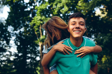 man carries a girl on his back