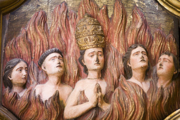 Baroque relief (18th century) showing a pope and other clergy people damned to the flames of hell,...