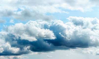 Naklejka na ściany i meble Blue sky background with clouds. Blue hues and outdoor.