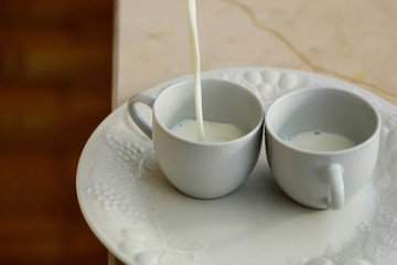 Pouring milk in cups