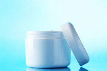 White cosmetic bottle on a blue background