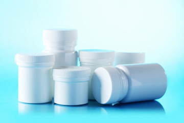 White cosmetic bottles on a blue background