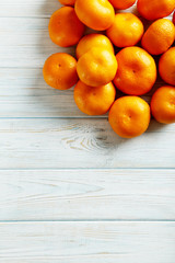 Ripe mandarins on a blue wooden table