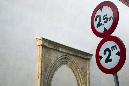Traffic signs in a narrow street, Seville city center, Spain