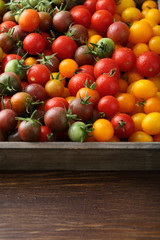 Ripe tomatoes in wood crate