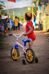 Little girl with bicicle in occupation camp