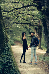 Fototapeta na wymiar fashionable couple in green forest
