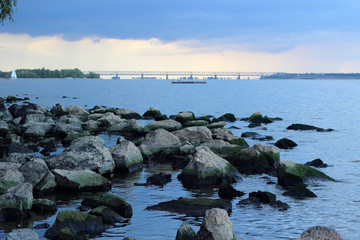 Stones on the bank of the river, summer evening