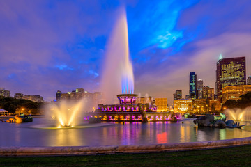 Chicago skyline panorama with skyscrapers and Buckingham fountain in Grant Park at night lit by...