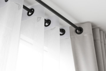 The white curtains with ring-top rail