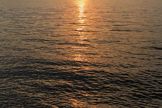 The rays of the setting sun playing on the water surface