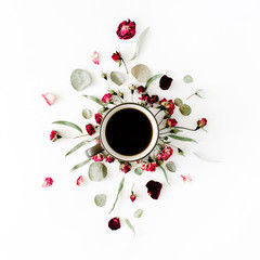 black coffee mug and red rose buds bouquet with eucalyptus on white background. flat lay, top view