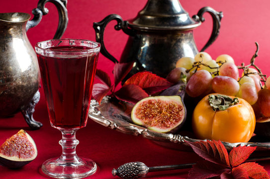 Autumn still life with figs and berry infusion