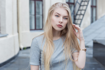 Fototapeta premium beautiful sexy blonde girl with long hair and full lips walk into town