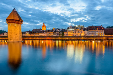 Night view towards Chapel Bridge (Kapellbruecke) together with the octagonal tall tower (Wasserturm) it is one of the Lucerne's most famous tourists attraction