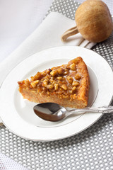 Piece of pumpkin pie with walnuts