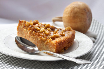 Piece of pumpkin pie with walnuts
