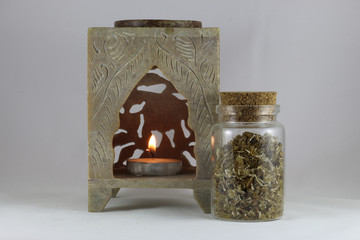 Natural aromatic musk incense in a bottle and a candle isolated on a white background - obrazy, fototapety, plakaty