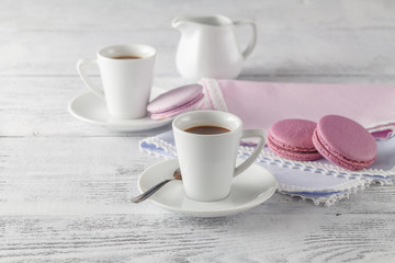 Obraz na płótnie Canvas Shabby chic style coffee cup and plate with macaroon cookie