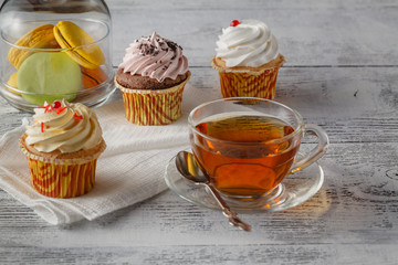 Sweet and colourful french macaroons with tea cup