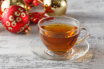 Christmas holiday background with tea cup, pine corn and ornamen