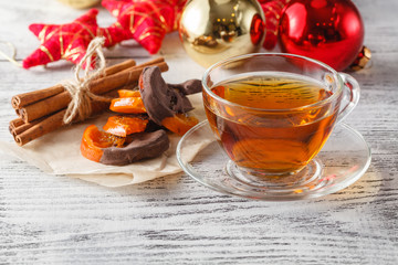 Christmas holiday background with tea cup, pine corn and ornamen