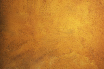 Old cement wall painted with orange. Concrete texture background