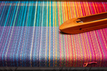 Weaving shuttle on the color warp