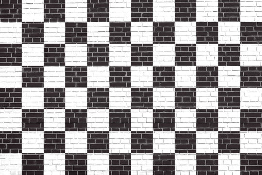 Checkered racing flag on brick wall texture