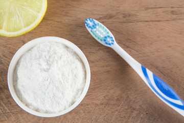 Toothbrush, baking soda and lemon