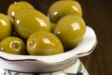 green olives in porcelain vase