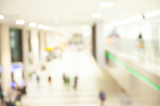 Blurred image of passengers walking along the departure hall in
