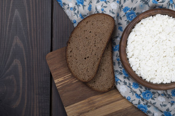 homemade fresh cottage cheese in wooden bowl with bread