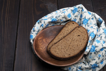 wooden plate with bread on a craft paper