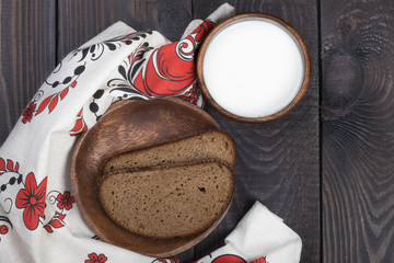 fresh bread on a wooden plate with cream and eggs on a countryside style