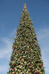 Giant Christmas tree against blue sky
