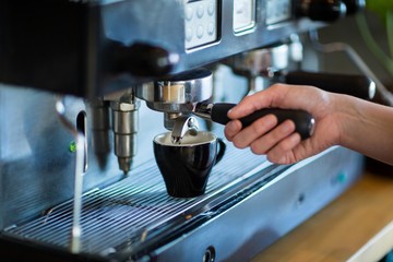 Waitress making cup of coffee