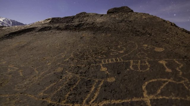 3 axis motion controlled astrophotography time lapse with dolly pull & pan left motion of moonset over Native American petroglyphs in Eastern Sierra, California -Long Shot-