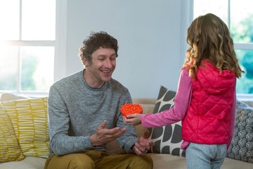 Daughter giving present to her father