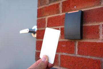using white entrance card at door entrance card reader