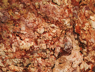 closeup shot of rough and cracked brown-red stone texture