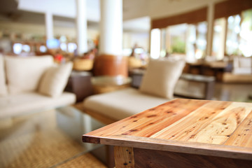 Empty wooden table on coffee shop background.