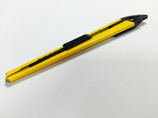 Yellow cutter on white background