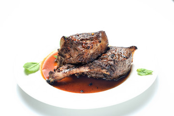 Grilled lamb steak on a plate on a white background