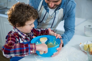 Father and son preparing cupcake