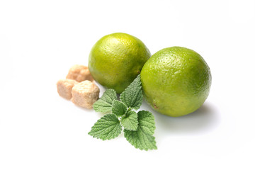 mint leaves, lime and brown sugar on a white background. Mojito cocktail ingredients