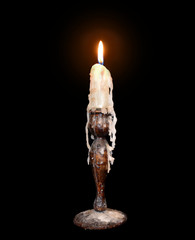 Lit candle in an old holder
