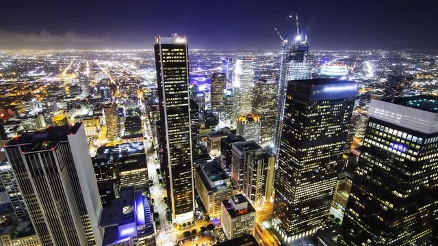 Time lapse overview with zoom in motion of city lights in downtown Los Angeles at twilight