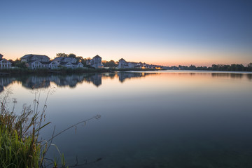 Fototapeta na wymiar Stunning dawn landscape image of clear sky over calm lake
